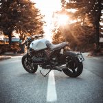 white and black BMW cruiser motorcycle in the center of road