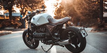 white and black BMW cruiser motorcycle in the center of road