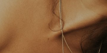 woman in white tank top wearing silver necklace